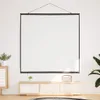 A projection screen is mounted on a white wall above a wooden media console. Produktbild-Vorschau