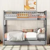 A gray bunk bed with a pull-out trundle bed, made of wood, is shown in a bedroom setting with a patterned rug and a piece of art on the wall. Anteprima dell’immagine prodotto