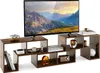 A television set is placed on a modular, multi-tiered wooden TV stand with various decorative items and books on its shelves. The background is plain white. Náhled obrázku produktu