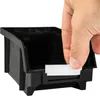 A hand places a label into a black storage bin. Anteprima dell’immagine prodotto