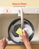 A person is cleaning a frying pan in a sink with soap and a sponge. Anteprima dell’immagine prodotto
