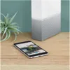 A smartphone is placed on a wooden desk next to a Western Digital My Cloud Home device and a plant. Náhled obrázku produktu