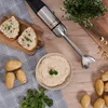 A KLAMER immersion blender set is displayed on a wooden table with various food items and ingredients, suggesting a culinary context. Produktbild-Vorschau