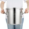 A person holding a stainless steel kitchen container. Produktbild-Vorschau