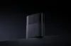 A black Xiaomi Mesh System router is placed on a dark surface against a black background. Náhľad obrázku produktu