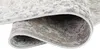 A close-up view of a rolled-up rug, showing the texture and pattern of the material. Produktbild-Vorschau