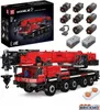 A product shot of a large red mobile crane construction toy set, with its packaging and components displayed. Voir les images du produit