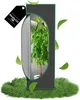 A grow tent with a plant inside, surrounded by grass and floating leaves. Voir les images du produit
