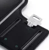 A close-up view of a black sport armband with a silver key inserted into a small pocket. Produktbild-Vorschau
