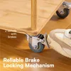 A close-up shot of a cart's wheels with a foot pressing down on a brake mechanism. The cart appears to be made of wood and has metal casters. Produktbild-Vorschau