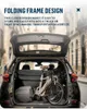 A folded electric bicycle is placed in the trunk of a car, with a bag next to it. Produktbild-Vorschau