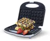 An open waffle maker with waffles and strawberries on it. Anteprima dell’immagine prodotto