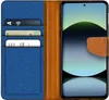 A flip case wallet for a smartphone, showing the inside with card slots and the phone in place. Podgląd zdjęcia produktu