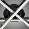Close-up view of a modern black ceiling light with intersecting arms and integrated LED lighting. Produktbild-Vorschau