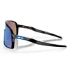 A pair of black Oakley Sutro sunglasses with blue lenses and blue accents on the frame, shown from a side angle on a white background. Náhled obrázku produktu