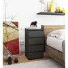 A bedroom scene with a nightstand next to a bed, featuring a painting and decorative items. Produktbild-Vorschau