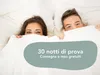 A couple peeking out from under a white duvet in bed. Anteprima dell’immagine prodotto