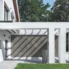 A modern house with a large wooden gate and a tall planter in front of it. Produktbild-Vorschau