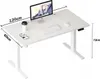 A white adjustable standing desk with a computer, keyboard, mouse, and coffee cup on it. Dimensions are labeled. Náhled obrázku produktu