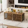 A dog crate furniture piece is shown in a living room setting with a fireplace and sofa in the background. Náhľad obrázku produktu