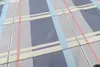 A close-up view of a blue plaid fabric. Podgląd zdjęcia produktu