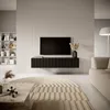 A modern living room with a TV mounted on a wall above a black media console, a beige sofa, and a decorative rug. Náhľad obrázku produktu