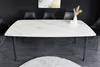 A dining table with chairs in a modern setting. Produktbild-Vorschau