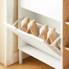 A white shoe cabinet with several beige high-heeled shoes inside. Náhľad obrázku produktu