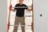 A man is installing a door frame using a specialized tool. Anteprima dell’immagine prodotto