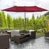 An outdoor patio scene with a large red umbrella providing shade over a seating area. Náhled obrázku produktu