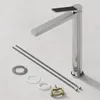 A chrome faucet and its installation accessories are laid out on a light gray surface. Náhľad obrázku produktu