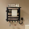 A black electric towel warmer mounted on a light brown wall, with towels, soap dispensers, and bath accessories displayed. Anteprima dell’immagine prodotto