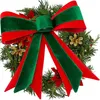 A close-up of a decorative Christmas wreath with a large red and green velvet bow. Produktbild-Vorschau