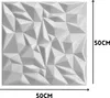 A white 3D wall panel with a geometric, faceted design, shown with dimensions indicated by arrows and text. Produktbild-Vorschau
