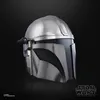 A close-up, side view of a silver and black Mandalorian helmet against a black background. Voir les images du produit