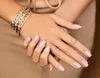 A close-up shot of a person's hands with manicured nails and jewelry. Náhled obrázku produktu