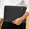 A person holds a black laptop sleeve. Produktbild-Vorschau