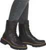 A pair of women's boots worn by a person. Voir les images du produit