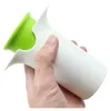 A hand holding a white and green vegetable cutter. Podgląd zdjęcia produktu