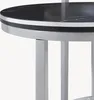 A close-up view of the edge of a round table with a black marble top and silver legs. Anteprima dell’immagine prodotto