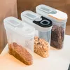 Three clear plastic food storage containers with lids, filled with different dry food items, are arranged in a row on a white surface. Produktbild-Vorschau