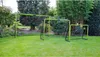 Three soccer goals of varying sizes are set up on a green lawn in a backyard setting, surrounded by trees and foliage. Anteprima dell’immagine prodotto