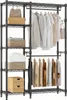 A metal wire shelving unit used as a wardrobe, displaying various clothing items and storage baskets. Produktbild-Vorschau