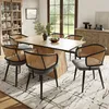 A dining room set with a wooden table and six chairs with rattan backs and gray upholstered seats. Podgląd zdjęcia produktu