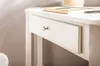 A close-up view of a white desk drawer with a silver knob, and a book on top of the desk. Anteprima dell’immagine prodotto