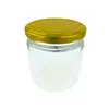 A clear studio shot of an empty glass jar with a gold lid. Náhľad obrázku produktu