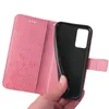 A hand is holding a pink floral flip phone case open, revealing the black interior where a phone would be placed. Produktbild-Vorschau