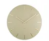 A round wall clock with gold hour markers and hands on a light green face. Voir les images du produit