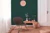 A cozy corner of a room with a chair, a small table with vases and decorative items, and a wall with a woven plate decoration. Produktbild-Vorschau