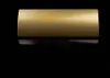 A close-up studio shot of a gold-colored door handle against a black background. Produktbild-Vorschau